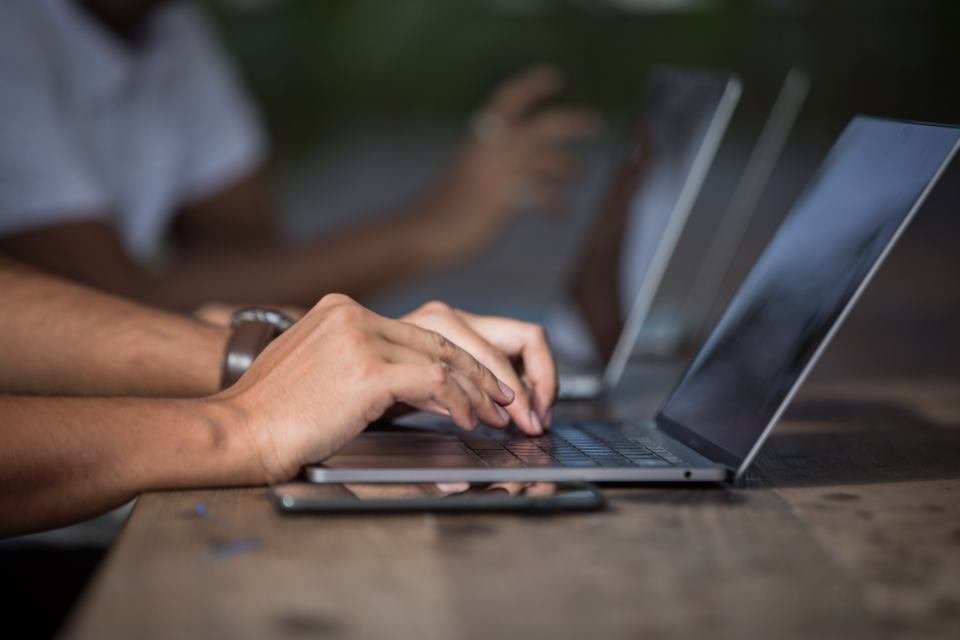 Team planning a website on a laptop